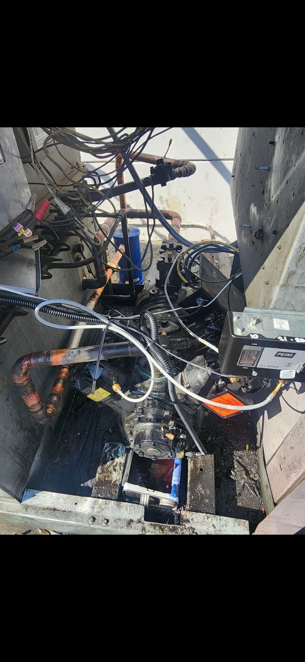 Complex machinery with exposed wiring and pipes, showcasing a mechanical setup.