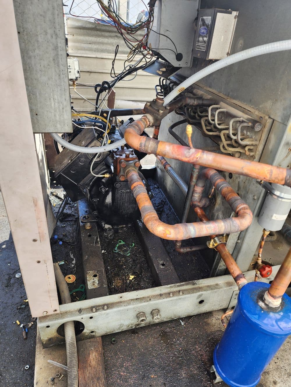 Industrial refrigeration unit interior with copper pipes and electrical components.